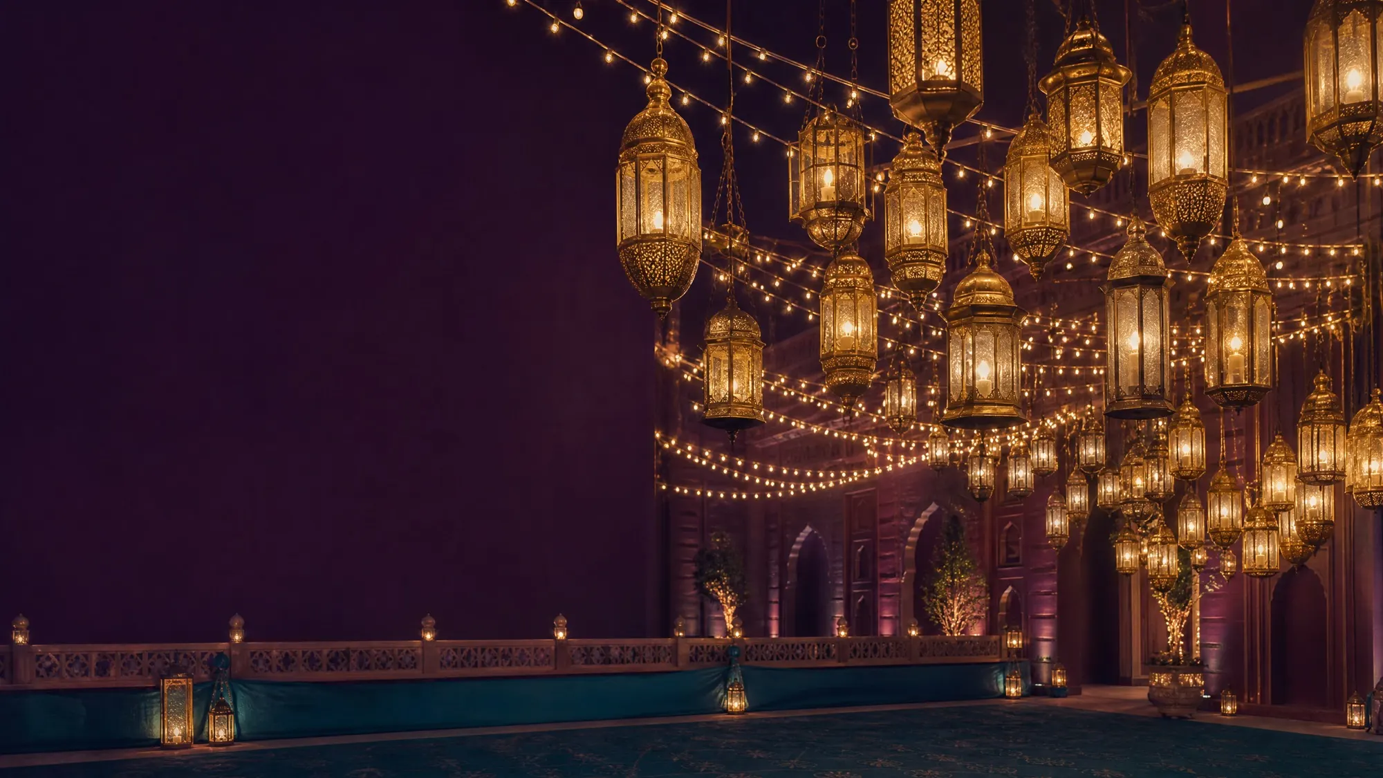 A canopy of hanging lanterns and string lights spills gold over a quiet courtyard wall.